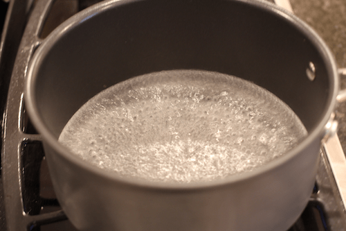Water simmering in a medium pot on the stove.