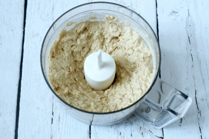 Hummus being made in a small food processor.