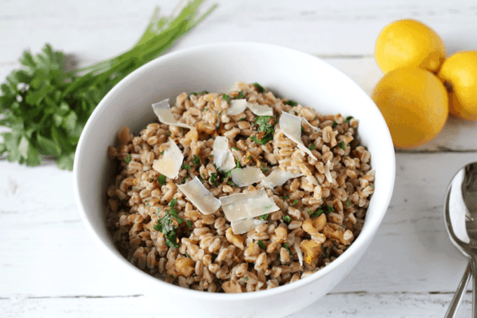 Cooked farro with parsley and Parmesan in a white bowl