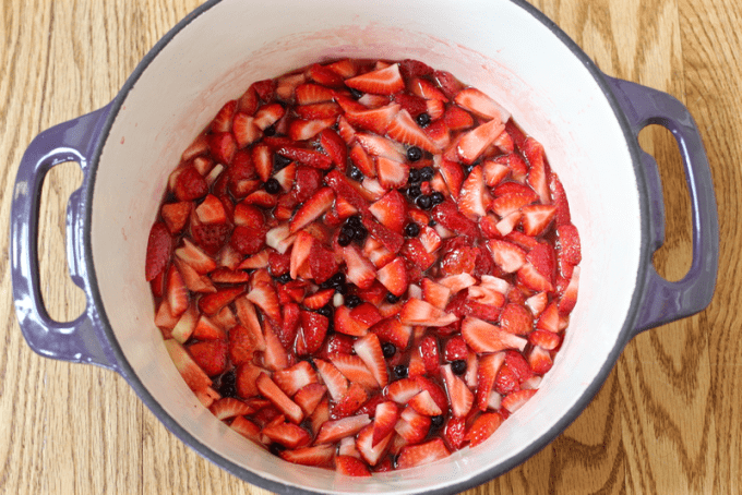 A large purple pot with diced strawberries