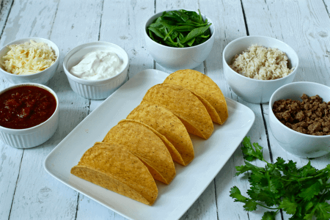 Taco night ingredients laid out in separate bowls and plates