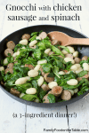 A wooden spoon resting in a skillet of gnocchi with sausage and spinach.