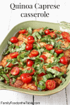 A green rectangular casserole dish full of a cheesy baked quinoa with tomatoes and basil.