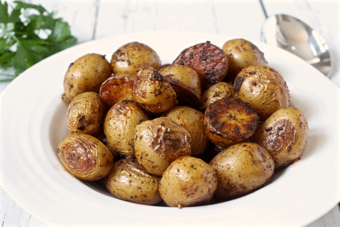 Roasted potatoes with paprika served piled up in a white bowl