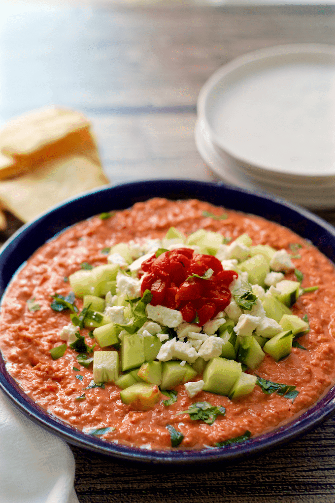 Holiday hummus has a roasted red pepper hummus base that gets dressed up with chopped cucumber and feta cheese for an easy, but fancy, holiday appetizer! #hummus #appetizers #holidays #holidayfood #partyfood #cocktailparty #holidayparty Holiday hummus - Roasted red pepper hummus gets dressed up with chopped cucumber and feta cheese for an easy, but fancy, holiday appetizer! | FamilyFoodontheTable.com