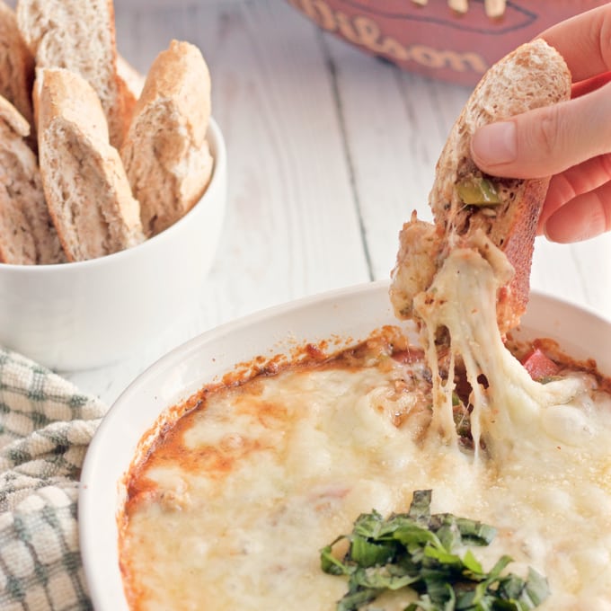 This veggie-loaded pizza dip is so super cheesy! | FamilyFoodontheTable.com