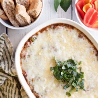 Cheesy veggie-packed pizza dip - great party appetizer everyone will love! | FamilyFoodontheTable.com