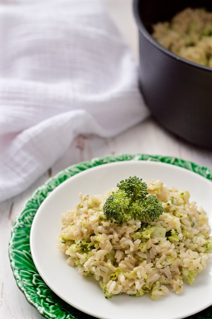 Broccoli cheese brown rice served on a plate with the pot in the background