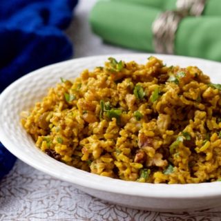 An easy one-pot cold curried rice salad with bright citrus notes and raisins, nuts and cilantro folded in | FamilyFoodontheTable.com