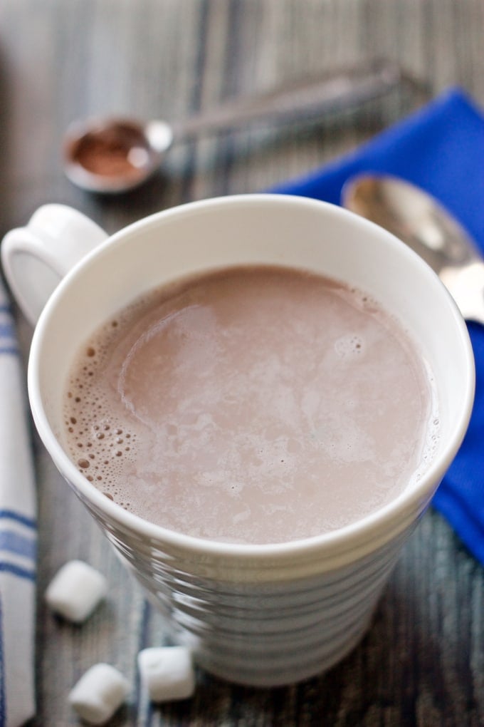 A coffee mug full of hot cocoa 