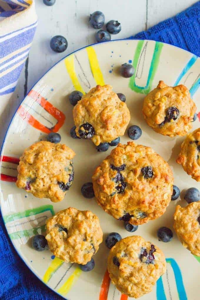 Large and mini blueberry banana muffins on a colorful plate.