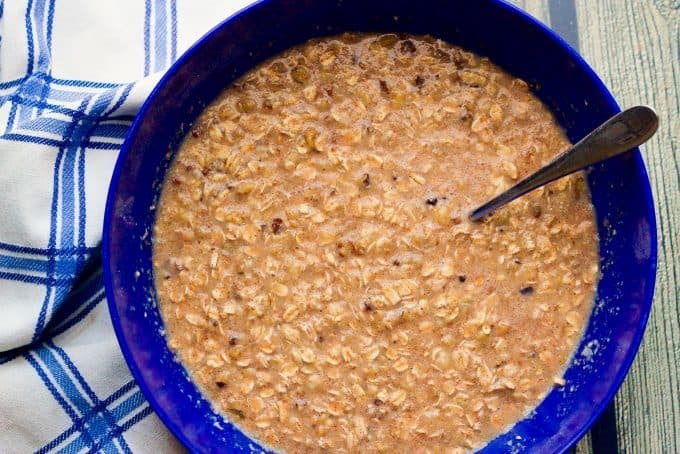 Batter for baked oatmeal in a large blue bowl