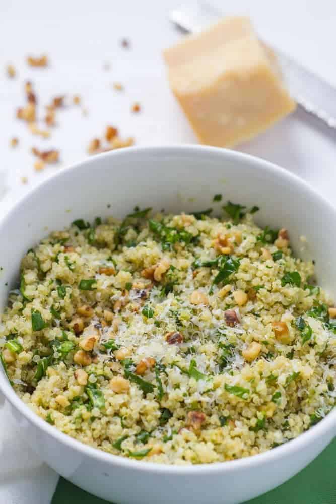 This light, flavorful quinoa spinach salad with pesto and nuts makes an easy weeknight side dish or lovely vegetarian lunch! #quinoasalad #pesto #healthyrecipes #vegetarianrecipes