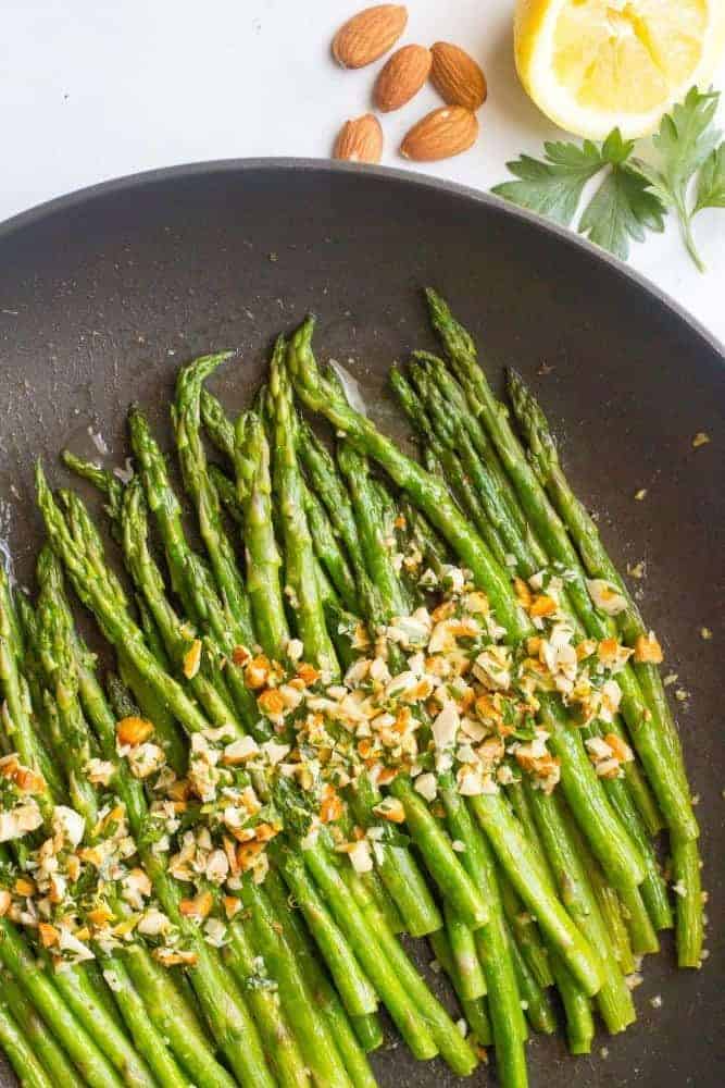 Asparagus almondine is an easy, healthy, 15-minute side dish that’s sure to impress! The almondine mixture of almonds, butter, fresh herbs and lemon adds great flavor! #asparagus #sidedish #spring