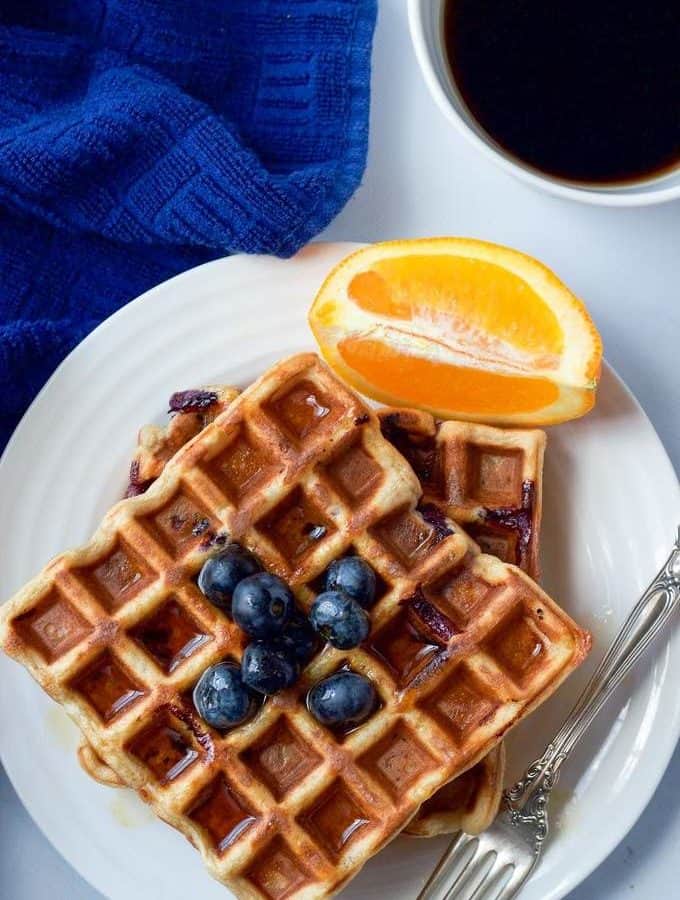 Whole wheat blueberry waffles with an orange maple syrup - a great easy breakfast or brunch recipe!