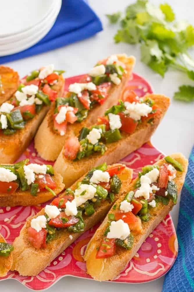 A plate full of bruschetta being served