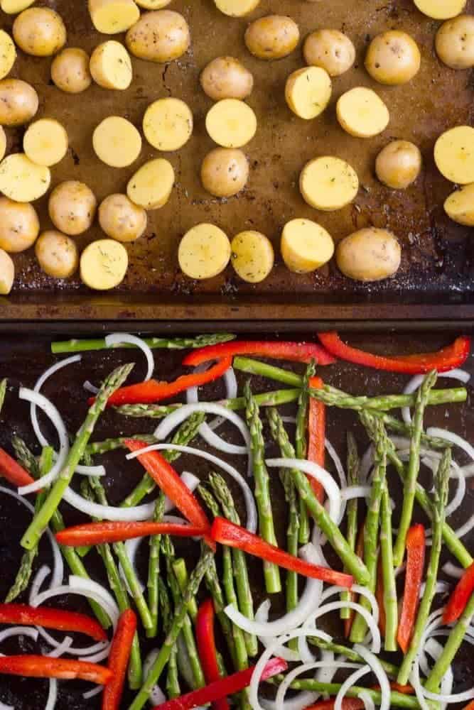 Sheet pans ready to roast of baby potatoes and fresh vegetables