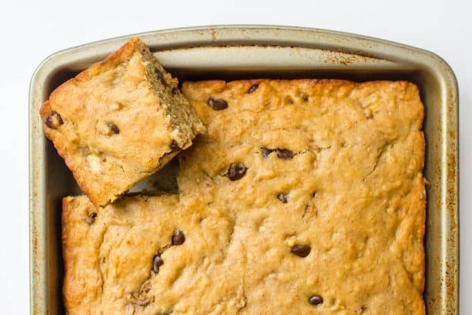 This easy banana chocolate chip snack cake is fluffy, moist and full of chocolate chips! It's whole wheat and naturally sweetened and makes a great sweet treat any time of day! #banana #snack #healthysnack #kids #cake