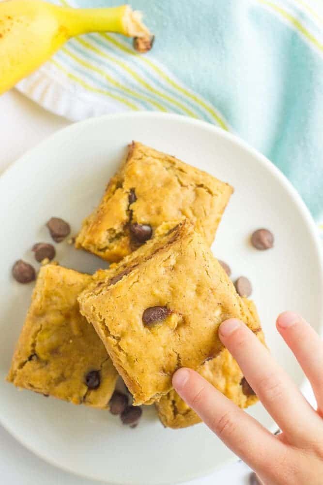 This easy banana chocolate chip snack cake is fluffy, moist and full of chocolate chips! It's whole wheat and naturally sweetened and makes a great sweet treat any time of day! #banana #snack #healthysnack #kids #cake