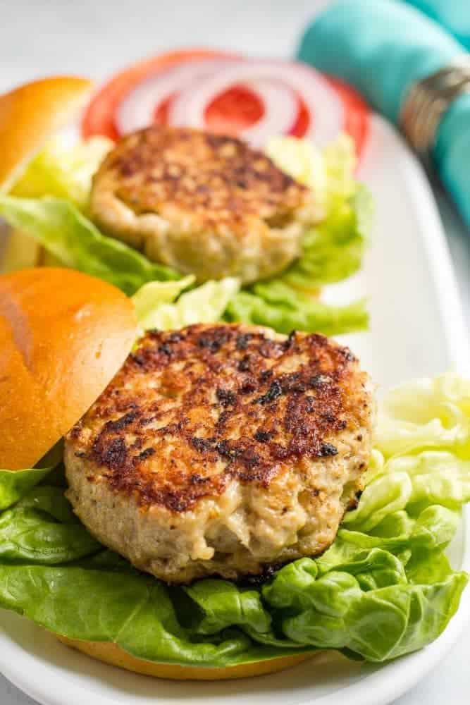 Cheddar chicken burgers served on buns with leafy lettuce