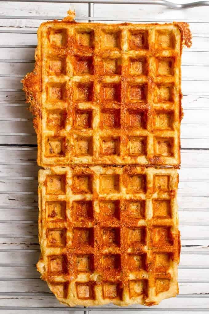Two large square waffles on a cooling rack.