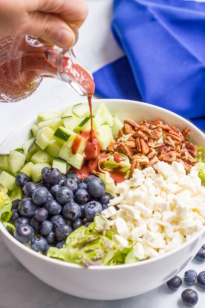 Easy summer salad with cucumbers, blueberries, pecans and feta cheese, topped with a delicious balsamic blueberry vinaigrette! | FamilyFoodontheTable.com