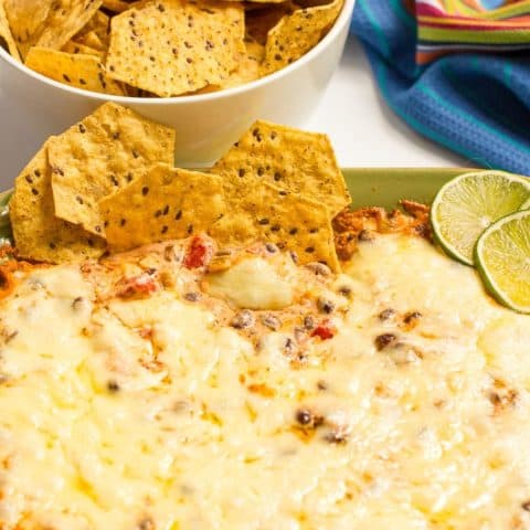 Cheesy baked black bean dip -- hot and bubbly and served with tortilla chips for an easy appetizer (great game day eats!)