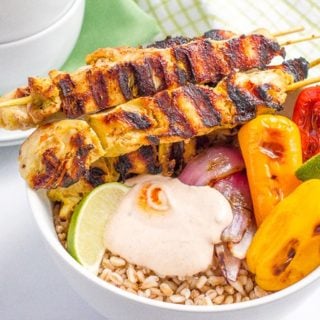Chili lime chicken kabobs in a bowl with farro, peppers and a creamy, smoky adobo sauce - a tasty, healthy summer dinner!