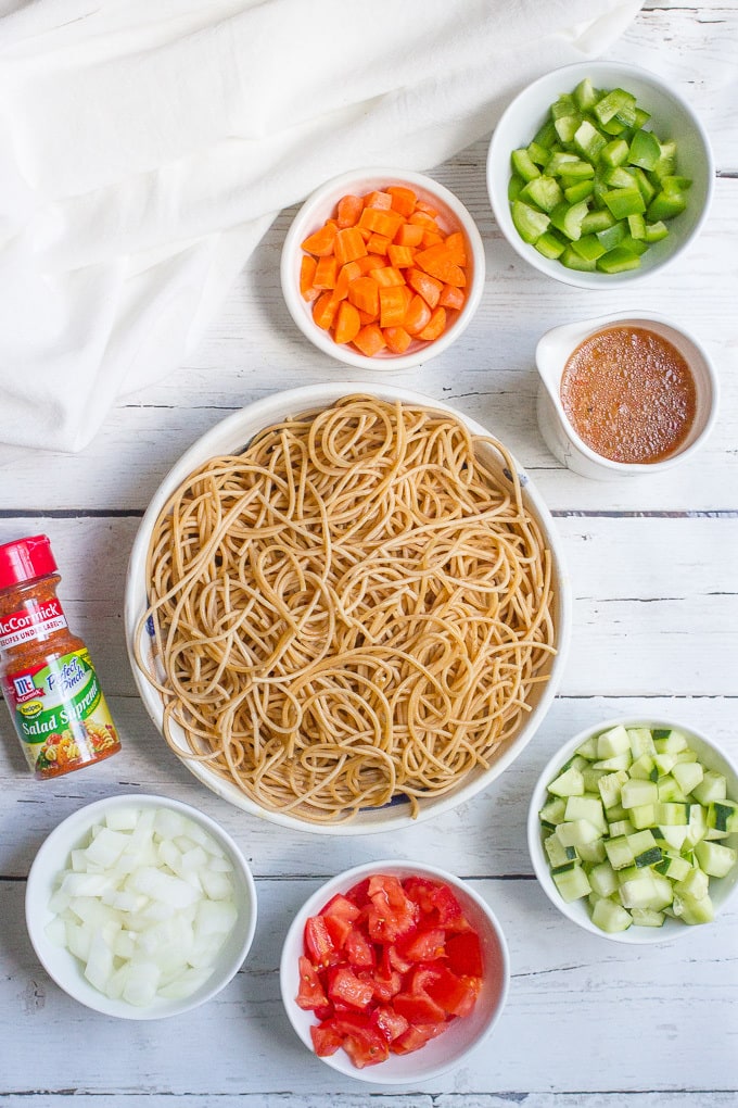 Classic spaghetti salad recipe with tomatoes, cucumber, green pepper, carrots and Italian dressing - perfect for sharing!