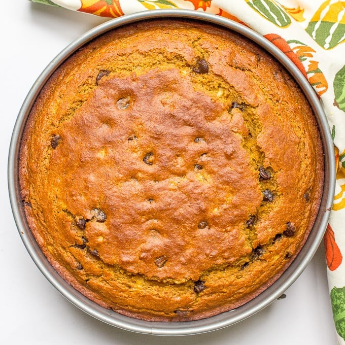 A slightly healthier banana pumpkin chocolate chip cake recipe with rich chocolate flavor and tall thick slices - a delicious fall dessert!