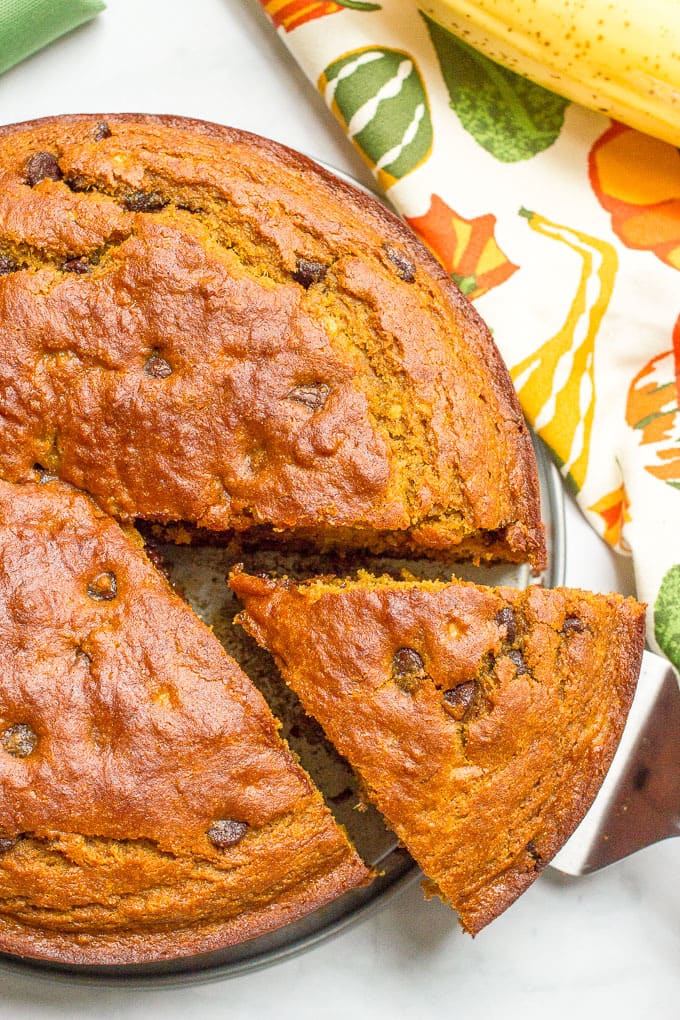 A slightly healthier banana pumpkin chocolate chip cake recipe with rich chocolate flavor and tall thick slices - a delicious fall dessert!