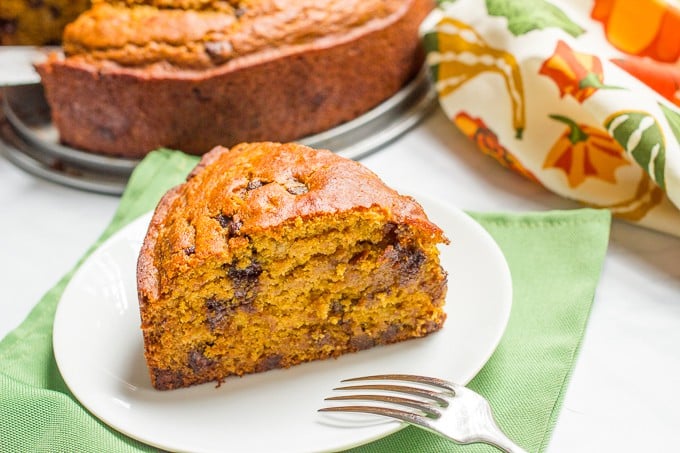 A slightly healthier banana pumpkin chocolate chip cake recipe with rich chocolate flavor and tall thick slices - a delicious fall dessert!