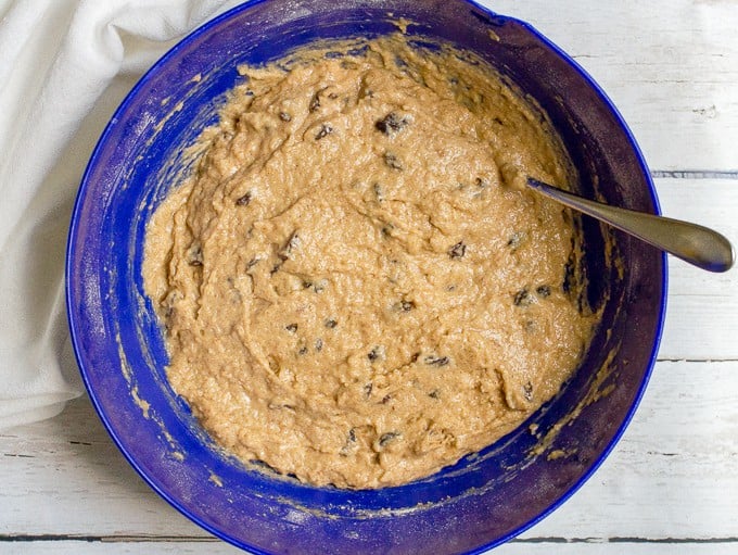 Bread batter in a large blue bowl with a spoon