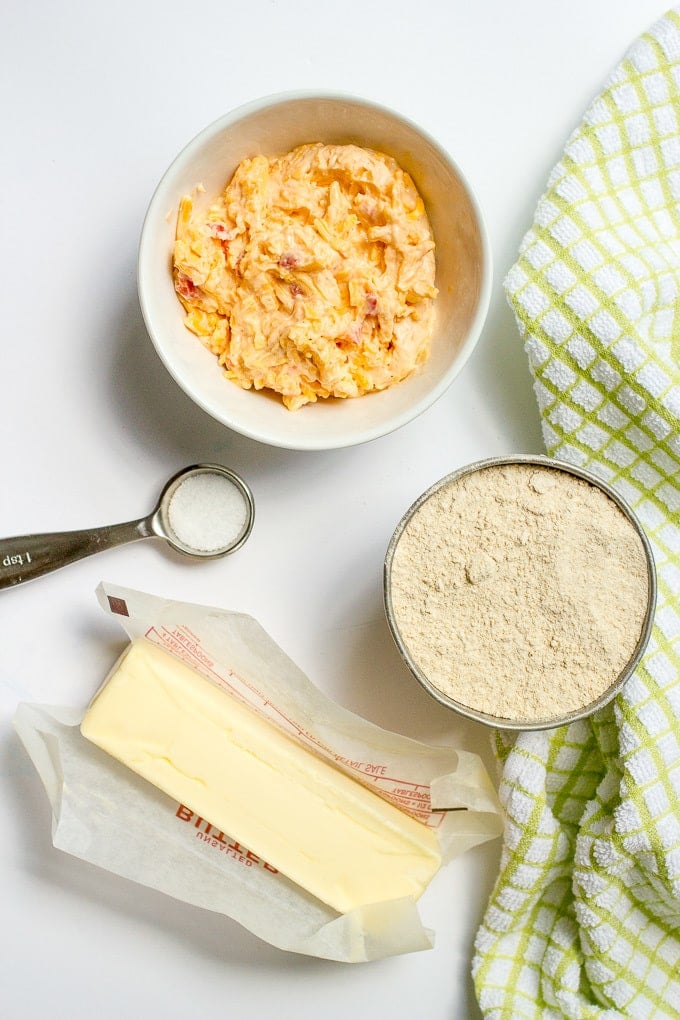 Butter, salt and separate bowls of flour and pimiento cheese laid out on a counter.