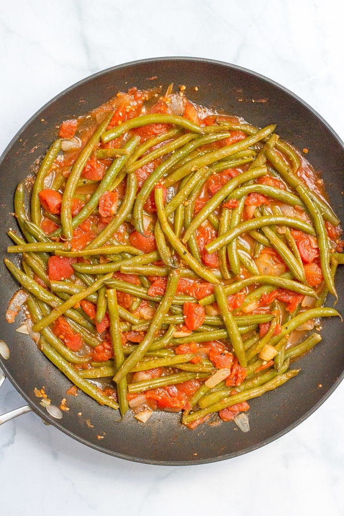 Sautéed green beans and tomatoes require just 4 ingredients and make for an easy, healthy and flavorful dinner side dish!