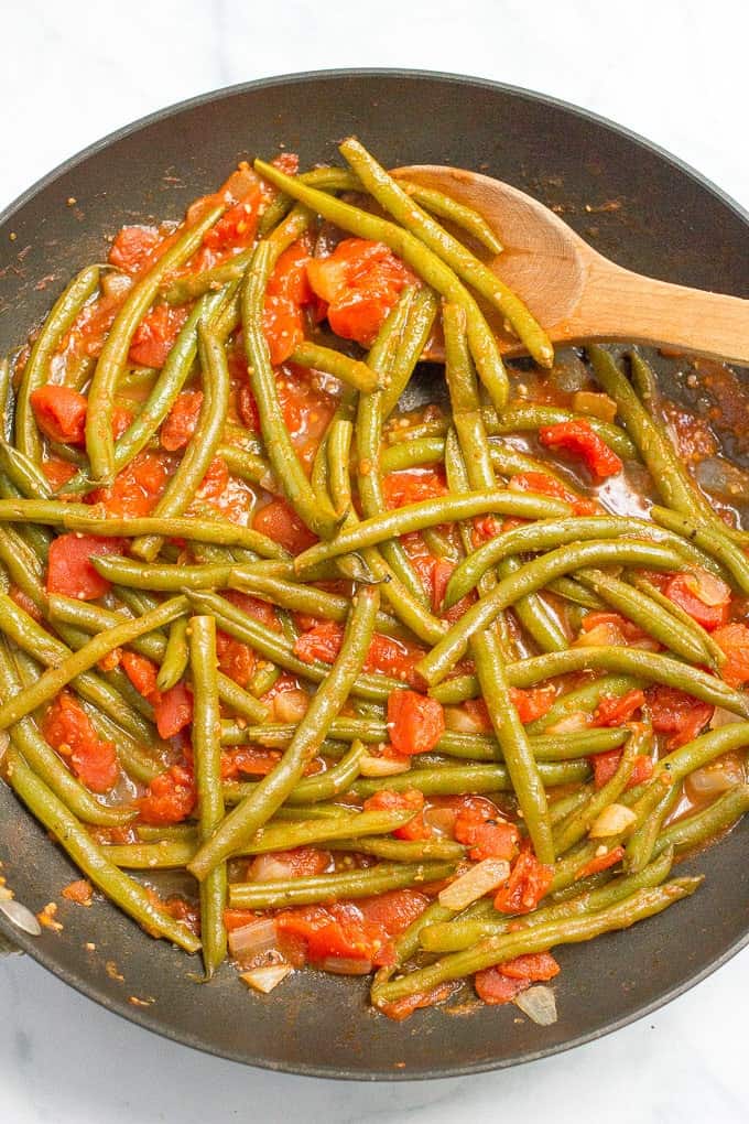 Sautéed green beans and tomatoes require just 4 ingredients and make for an easy, healthy and flavorful dinner side dish!