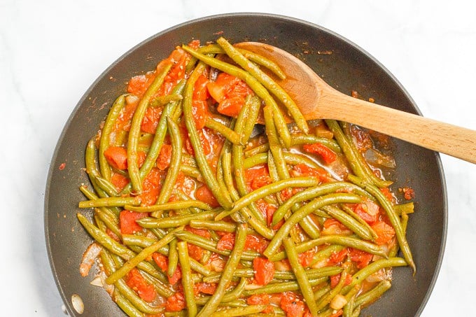 Sautéed green beans and tomatoes require just 4 ingredients and make for an easy, healthy and flavorful dinner side dish!