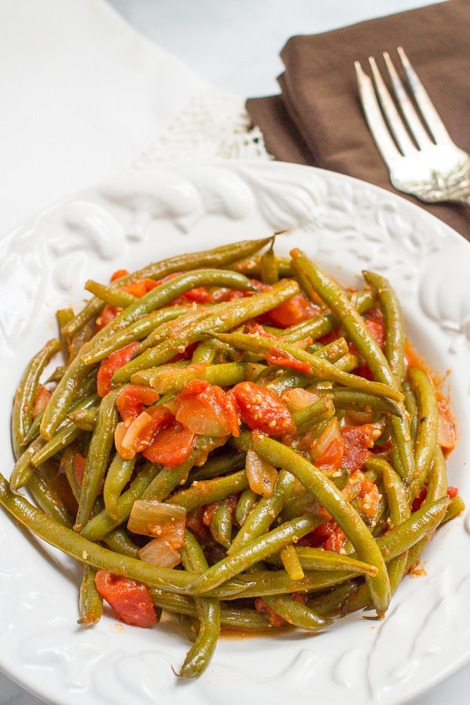 Sautéed green beans and tomatoes require just 4 ingredients and make for an easy, healthy and flavorful dinner side dish!