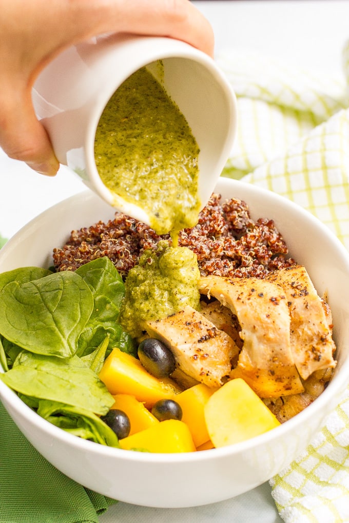 Chicken quinoa salad bowls are a quick and healthy dinner featuring chicken thighs, red quinoa, fresh fruit and a zesty lemon-mint dressing!