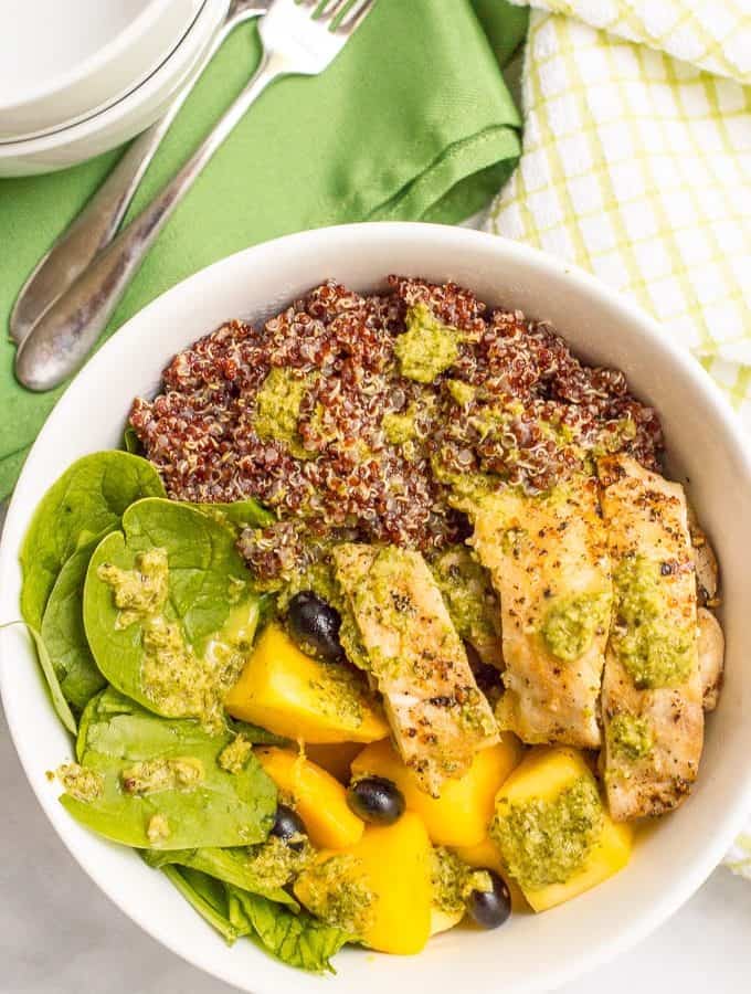 Chicken quinoa salad bowls are a quick and healthy dinner featuring chicken thighs, red quinoa, fresh fruit and a zesty lemon-mint dressing!