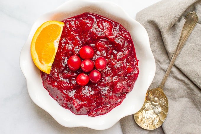 Easy cranberry sauce in a white serving bowl with a spoon nearby