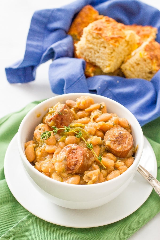 Slow cooker white beans and sausage is a delicious and easy dinner recipe with creamy beans, smoked turkey sausage and fresh herbs.