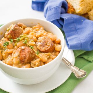 Slow cooker white beans and sausage is a delicious and easy dinner recipe with creamy beans, smoked turkey sausage and fresh herbs.