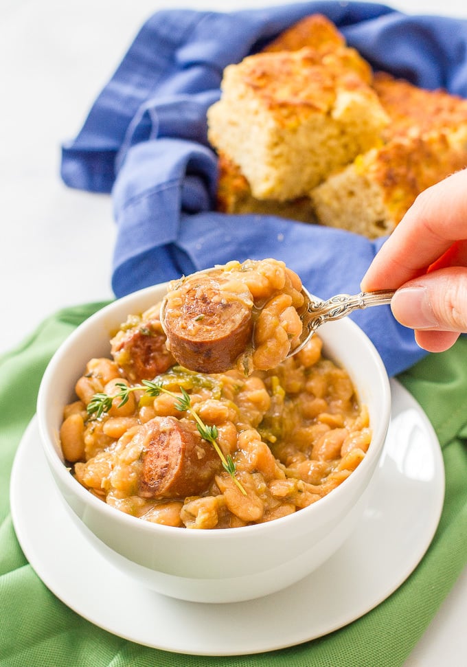 Slow cooker white beans and sausage is a delicious and easy dinner recipe with creamy beans, smoked turkey sausage and fresh herbs.
