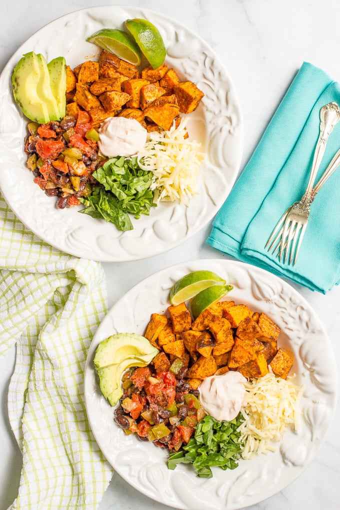 Taco-flavored vegetarian power bowls with sweet potatoes, black beans and a spiced yogurt sauce - an easy, healthy vegetarian dinner!