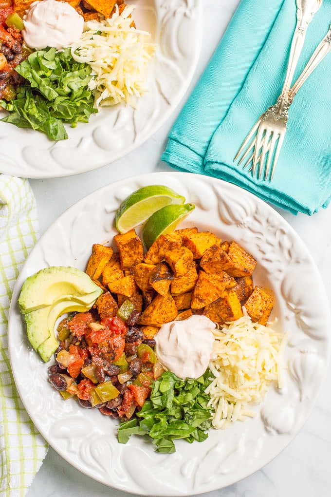 Taco-flavored vegetarian power bowls with sweet potatoes, black beans and a spiced yogurt sauce - an easy, healthy vegetarian dinner!