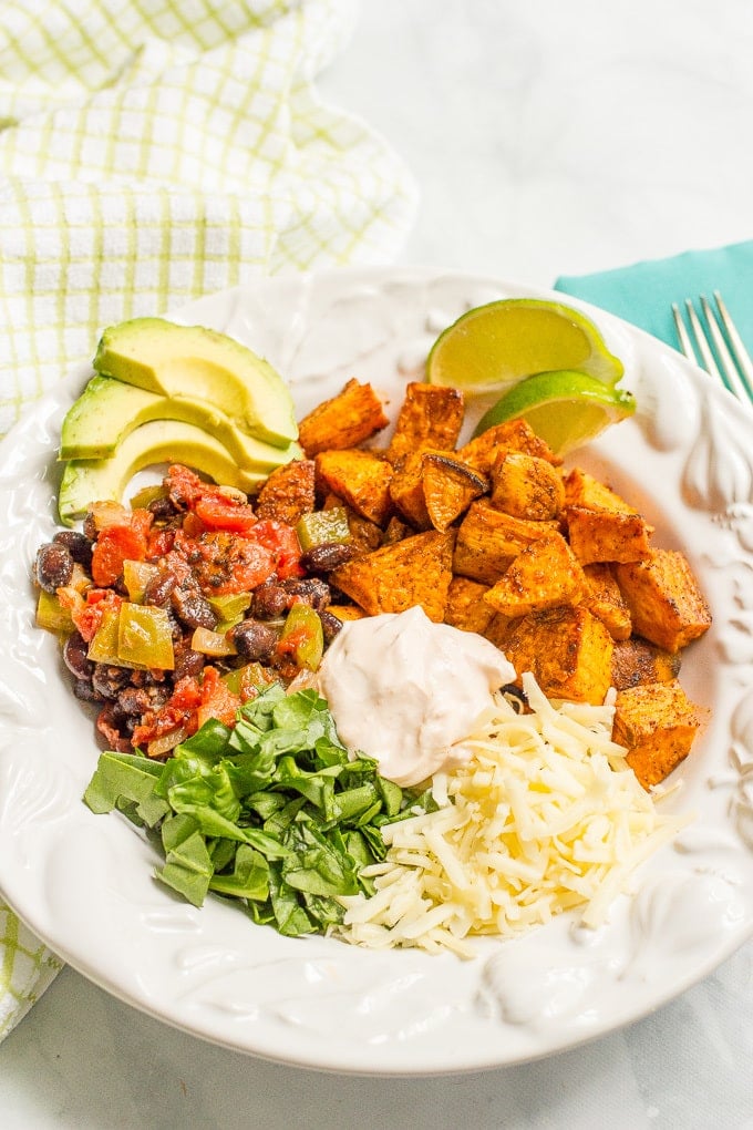 Taco-flavored vegetarian power bowls with sweet potatoes, black beans and a spiced yogurt sauce - an easy, healthy vegetarian dinner!