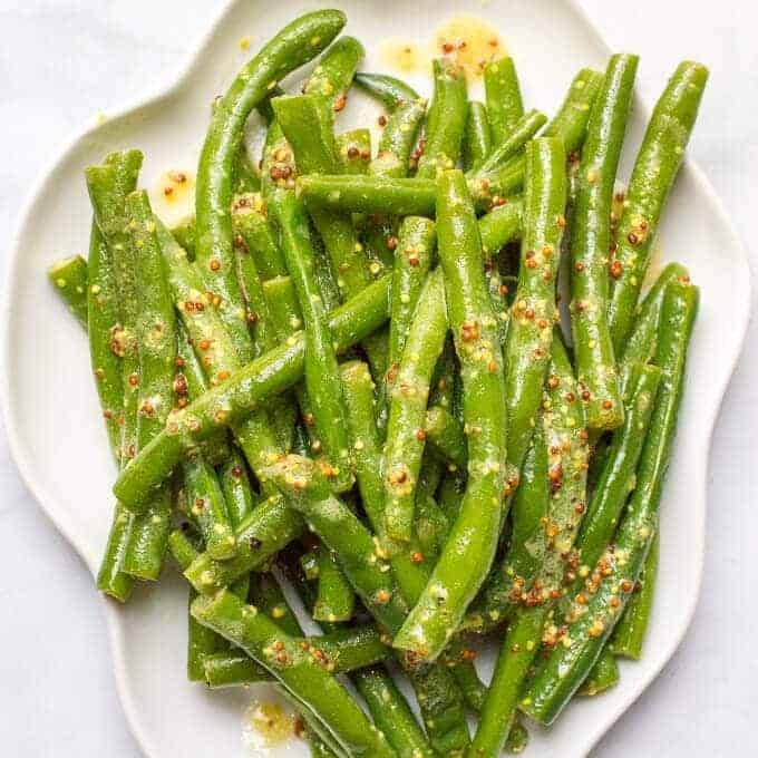 Green beans with mustard butter sauce is a quick and easy side dish with rich, tangy flavor and only 5 ingredients! | www.familyfoodonthetable.com