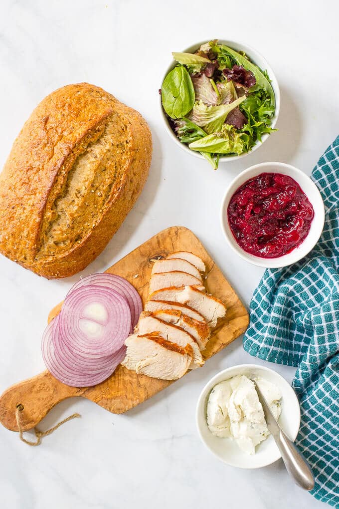 An easy turkey cranberry cream cheese sandwich with greens and red onion that’s the perfect way to use up leftover Thanksgiving turkey!