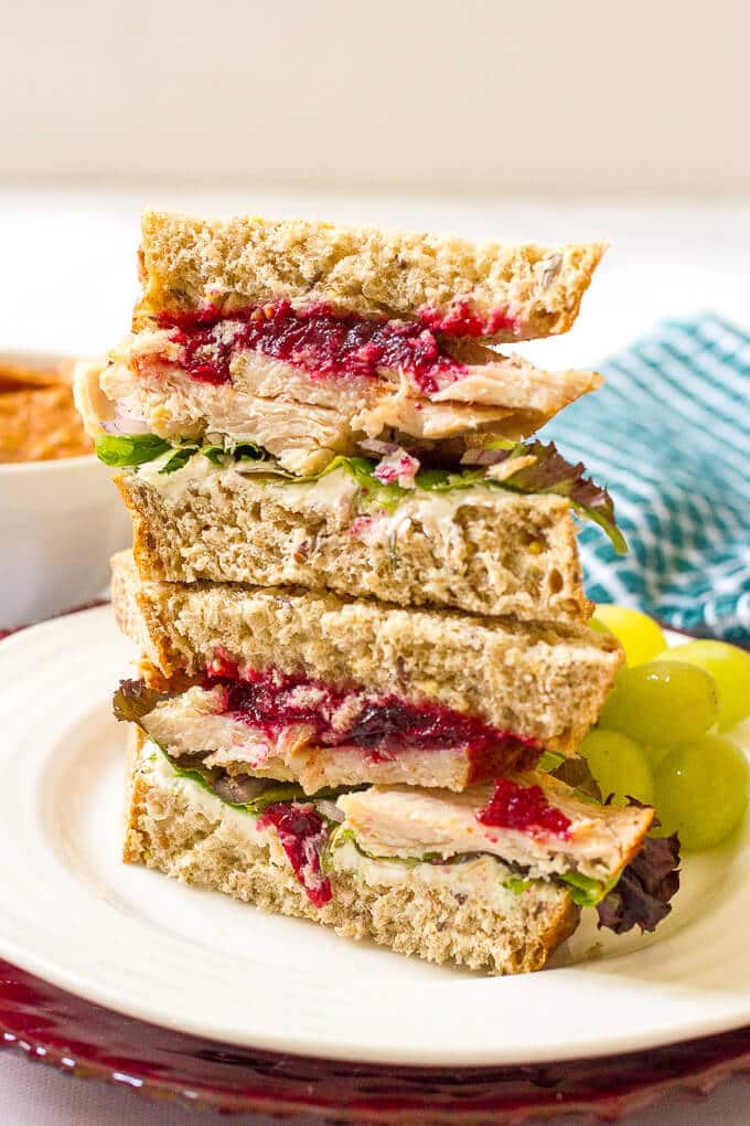 Leftover Thanksgiving turkey sandwiches with cream cheese, cranberry sauce, greens and red onion - a delicious easy lunch! | www.familyfoodonthetable.com